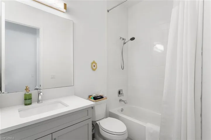 Full bathroom with shower / bath combo and vanity