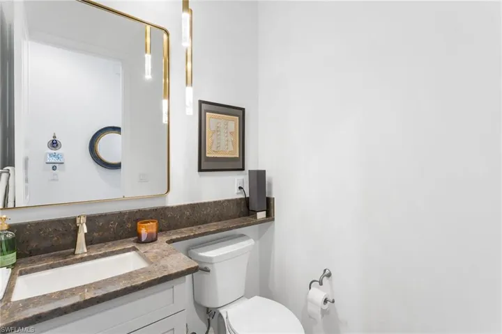 Half bathroom with vanity and toilet