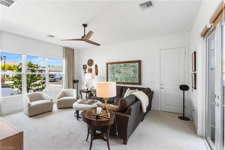 Living area with carpet and a ceiling fan
