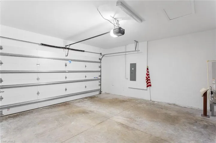 Garage with electric panel and a garage door opener