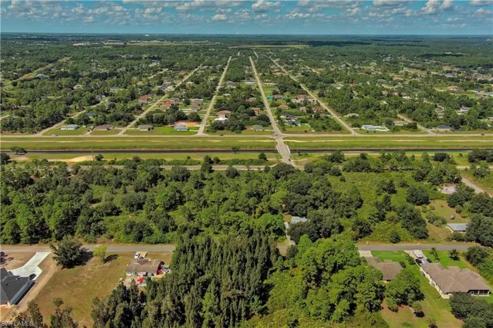 View of property location with a heavily wooded area