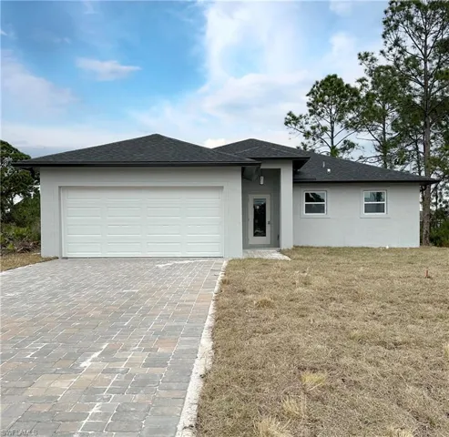 Prairie-style house with a garage and a front lawn