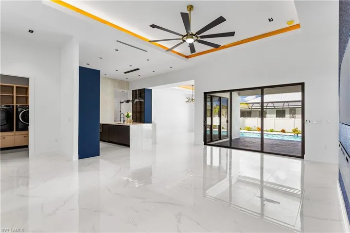 The LIVING ROOM, w/ its 16-ft COVE CEILING adorned w/ recessed LIGHTED WOOD, is nothing short of SPECTACULAR!