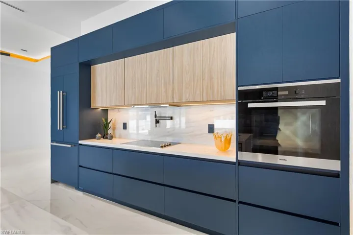 Luxury appliances such as wall oven, island microwave, induction cooktop w/ pot filler, panel-ready integrated dishwasher, and BUILT-IN REFRIGERATOR & FREEZER.