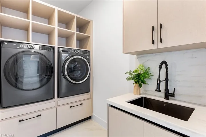 Additional features include well-equipped laundry room w/ laundry tub, and custom storage cabinets & built-in cabinets for GE washer & dryer.