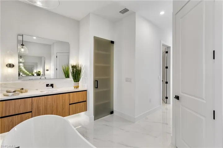 Linen closet with frosted door and custom built in cabinets & ELECTRIC TOILETS w/ BIDET functions add REFINEMENT & INDULGENCE.