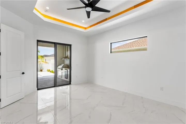 Retreat to SPACIOUS MASTER BEDROOM with private sliding doors to the lanai pool area.
