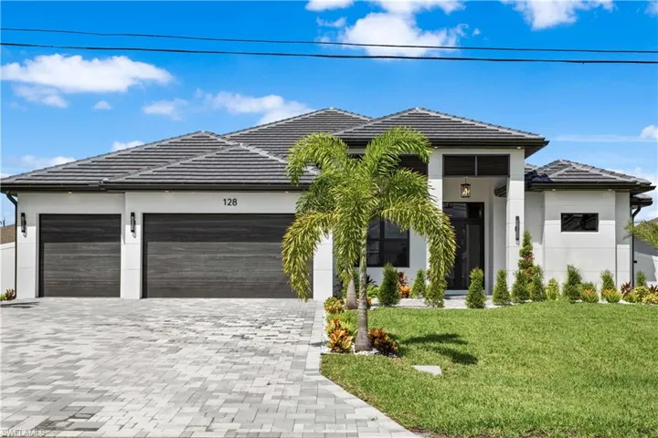 FRONT COLUMN PORCH w/ BAHAMA SHUTTERS and striking FLAT WOODEN CEILING led to stunning FROSTED DOUBLE FRONT DOORS that open into breathtaking FOYER.
