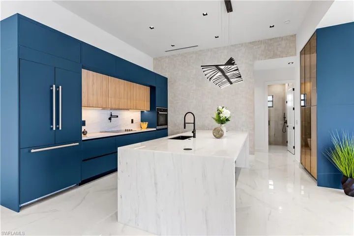 GOURMET KITCHEN displays EXQUISITE LAMP & CEILING SPOTLIGHTS. TOP-OF-THE-LINE custom CABINETRY with under cabinets lighting, QUARTZ COUNTERTOPS & FULL BACKSPLASH.