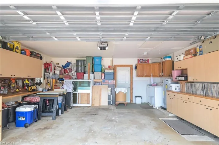 Garage featuring a workshop area and a garage door opener