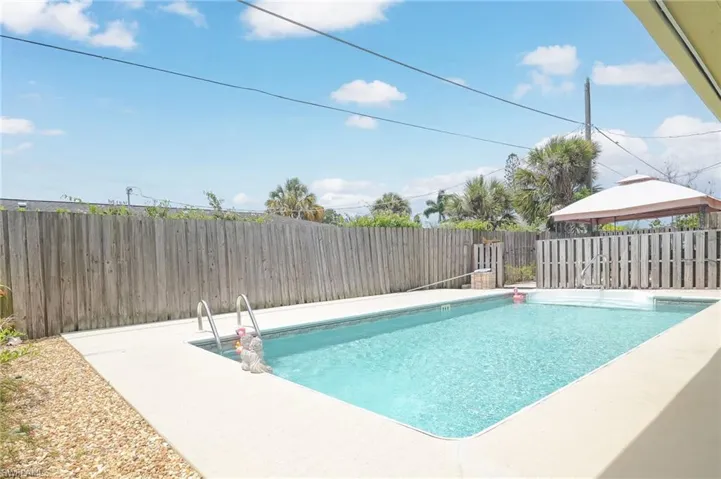 View of pool with a patio and a gazebo