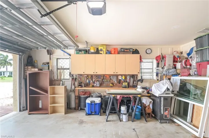 Garage featuring a workshop area and a garage door opener