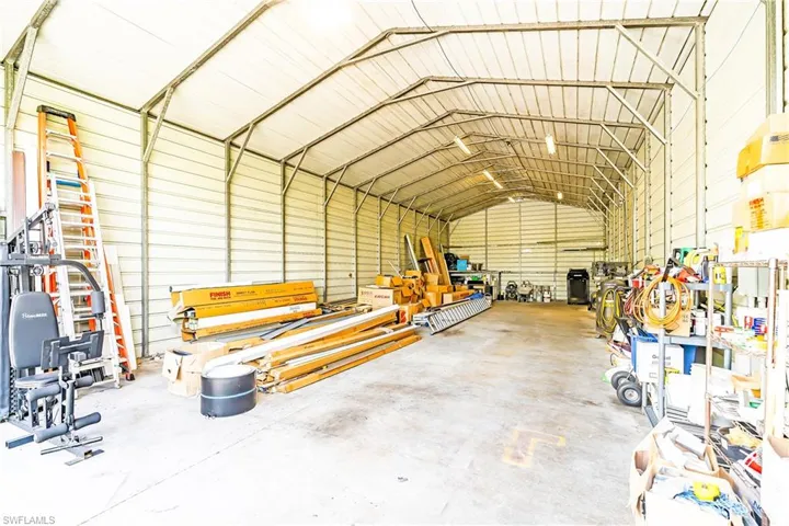 Metal frame structure with corrugated metal walls and roof