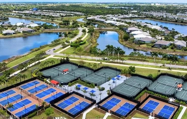 Birds eye view of property with a water view