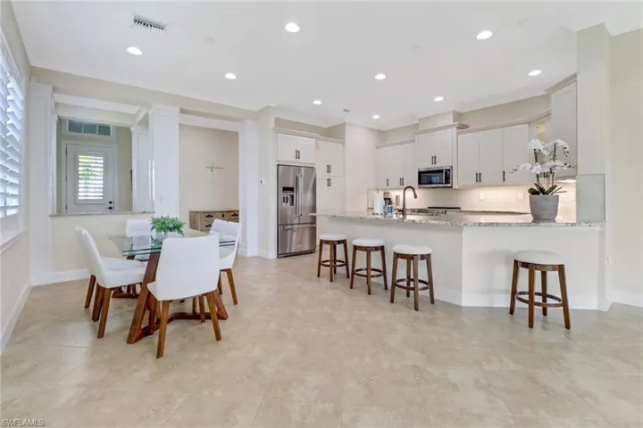 Dining area featuring ornamental molding, light tile patterned flooring, and recessed lighting