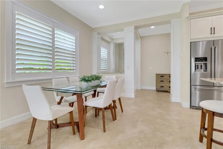 Dining room with ornamental molding and recessed lighting