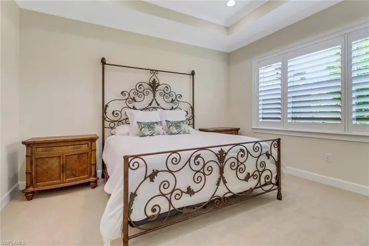 Carpeted bedroom with baseboards and recessed lighting
