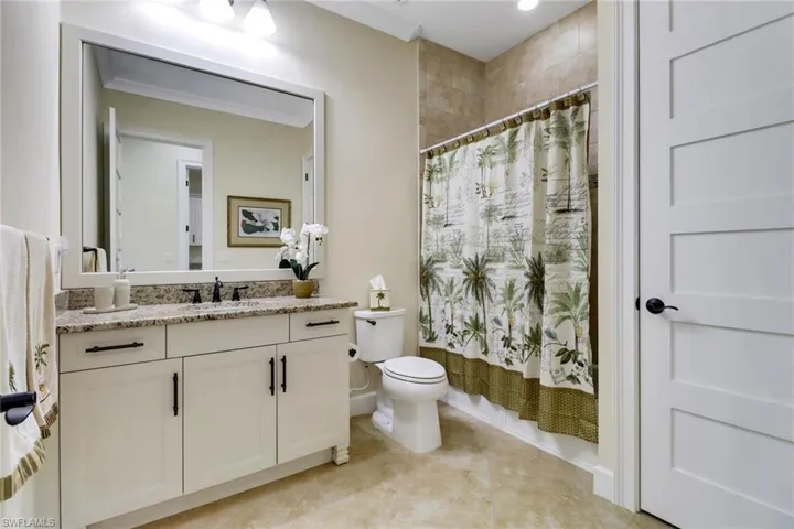 Bathroom with vanity, tile patterned floors, and shower / bathtub combination with curtain