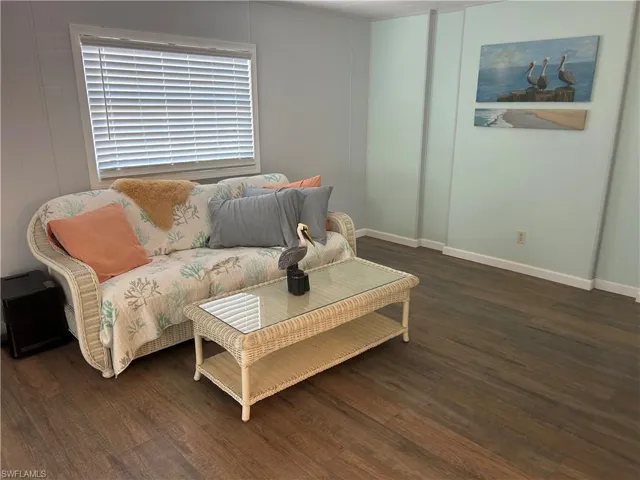 Sitting room with dark wood-style flooring