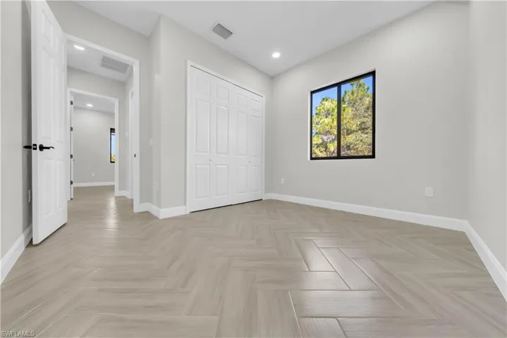Unfurnished bedroom with a closet and recessed lighting