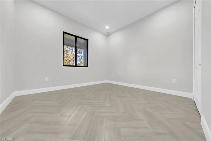 Empty room featuring baseboards and recessed lighting