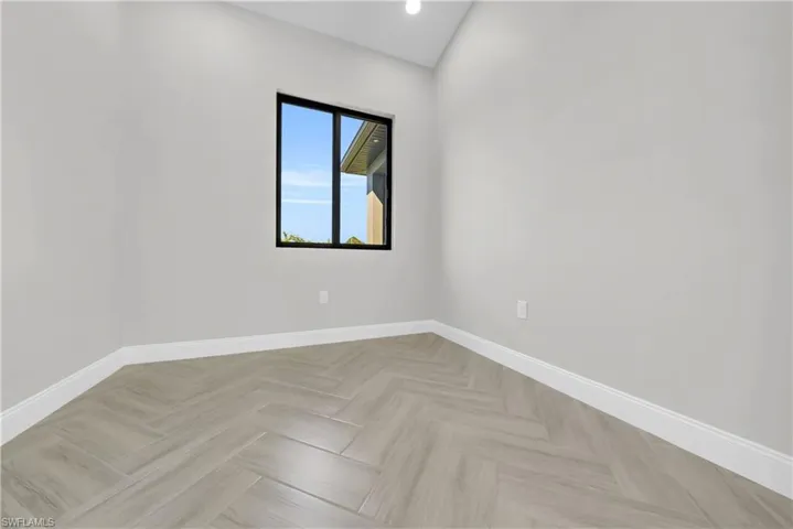 Empty room featuring baseboards and recessed lighting