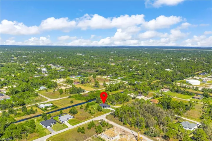 Aerial overview of property's location with a heavily wooded area