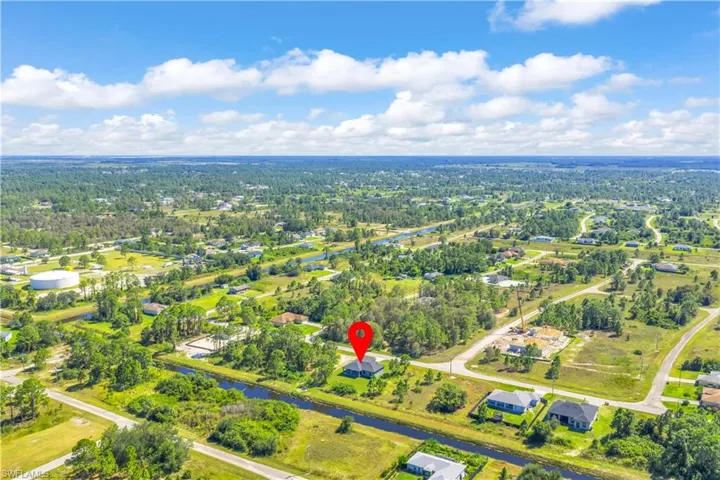 Aerial overview of property's location with a nearby body of water and nearby suburban area