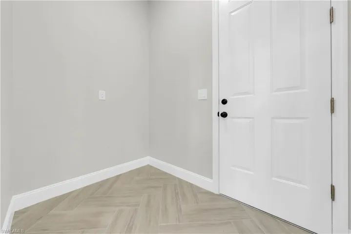 Doorway to outside with baseboards