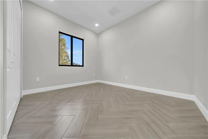 Unfurnished room with baseboards and recessed lighting