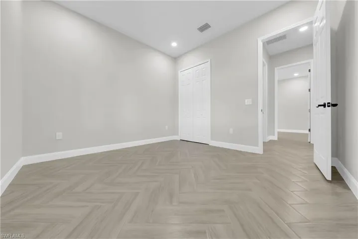 Unfurnished bedroom featuring recessed lighting and a closet