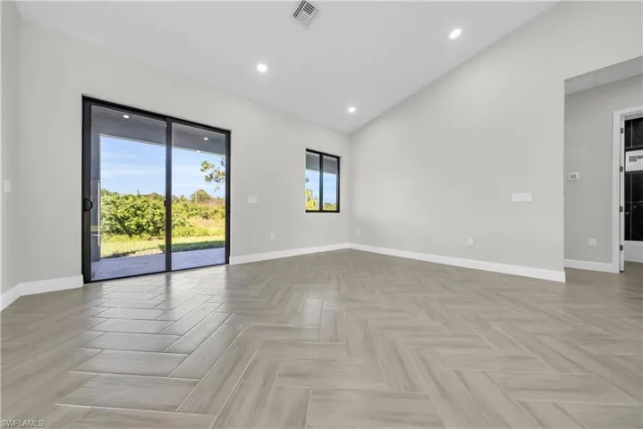 Spare room featuring recessed lighting and lofted ceiling