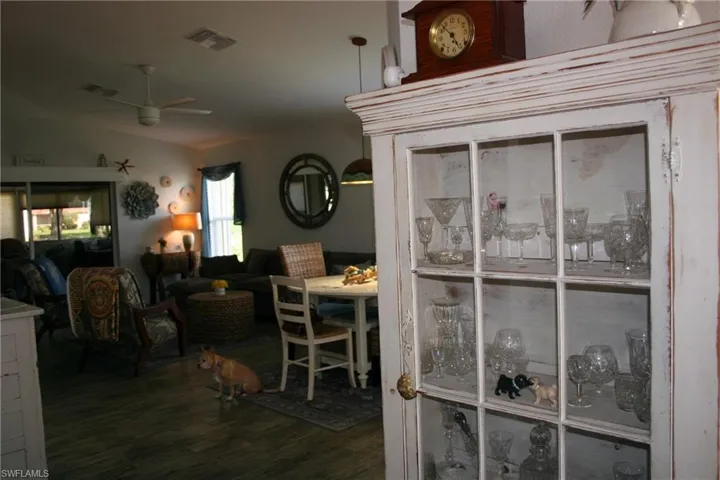 Charming living spaces featuring dark wood-finish flooring, exposed ceiling fans, and warm ambient lighting