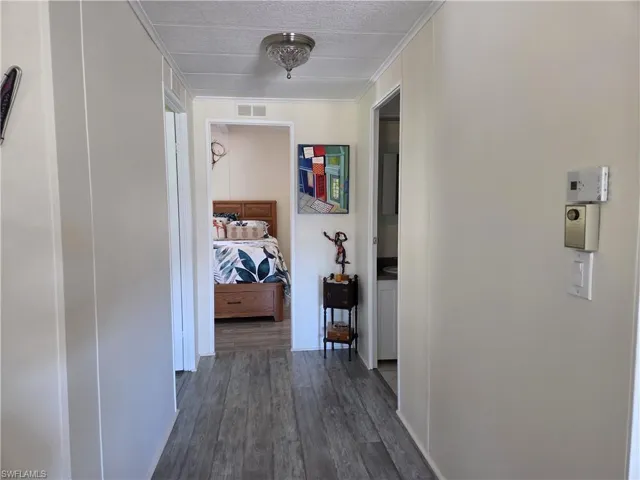Hall with dark wood-type flooring
