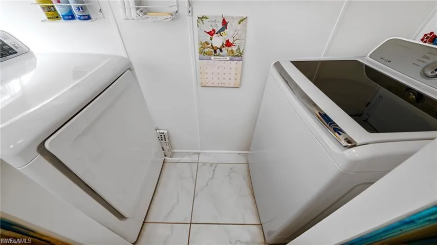 In home laundry room with separate washer and dryer