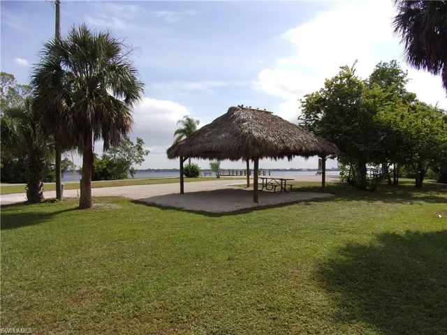 View of home's community with a gazebo, a patio area, and a water view
