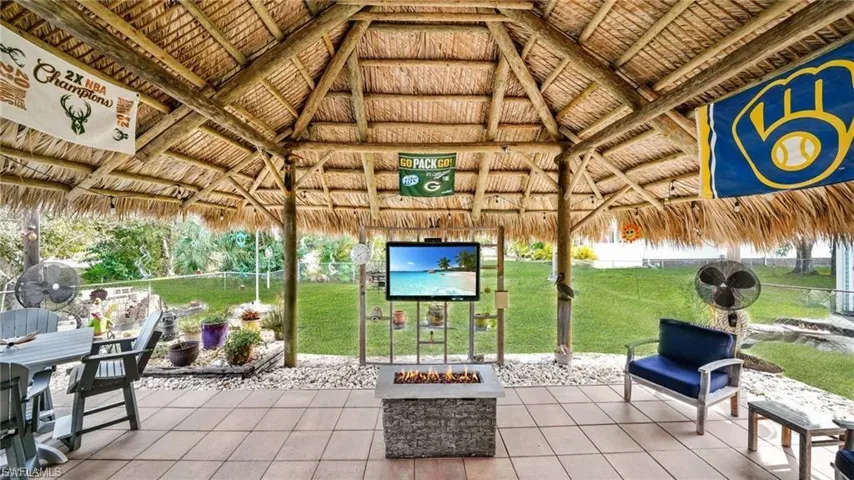In the furnished Tiki HutThe TV and fire pit are included.  Game day fun!