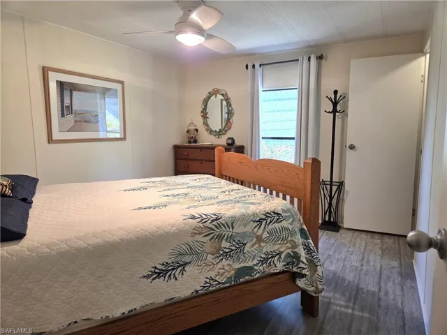 Bedroom featuring dark wood finished floors and a ceiling fan