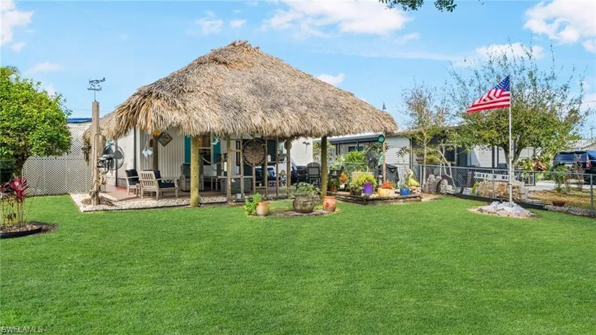 Back of property with a fenced backyard and a patio