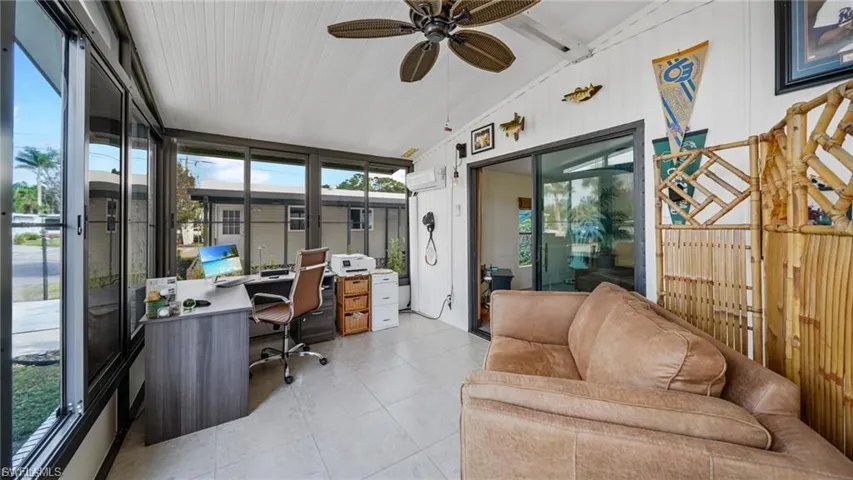 Office featuring vaulted ceiling, a ceiling fan, and light tile patterned floors