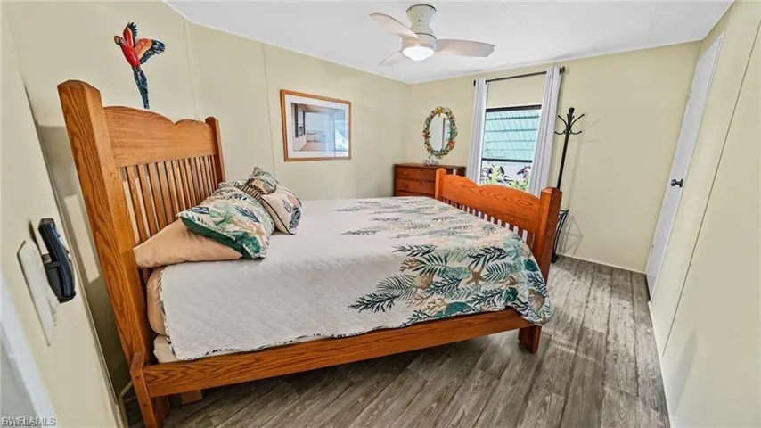 Guest Bedroom with wood finished floors and a ceiling fan