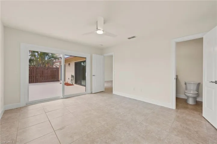 Spare room featuring a ceiling fan, baseboards, and light tile patterned floors