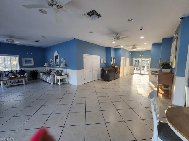 Living area featuring ceiling fan, light tile patterned floors, and recessed lighting
