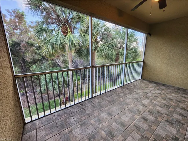 Unfurnished sunroom with ceiling fan