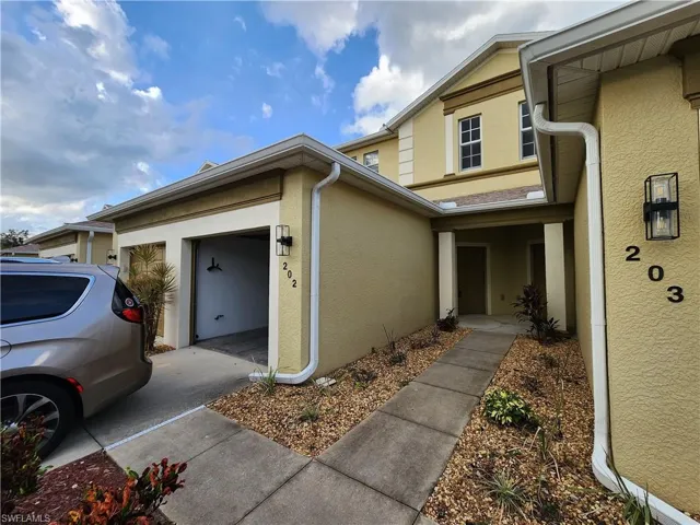 Doorway to property with a garage