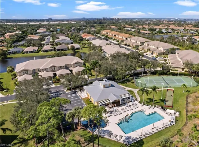 Aerial perspective of suburban area featuring a nearby body of water