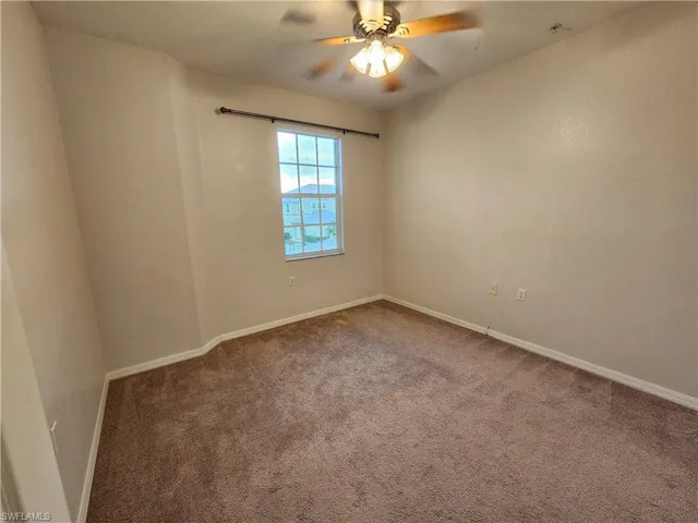 Spare room with carpet flooring and ceiling fan