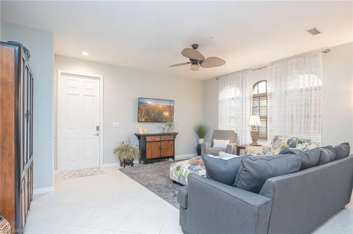 Tiled living room with ceiling fan