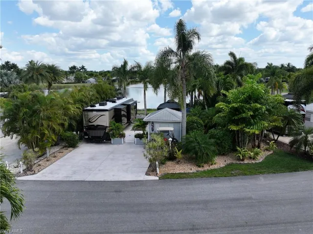 View of front facade featuring driveway and a water view