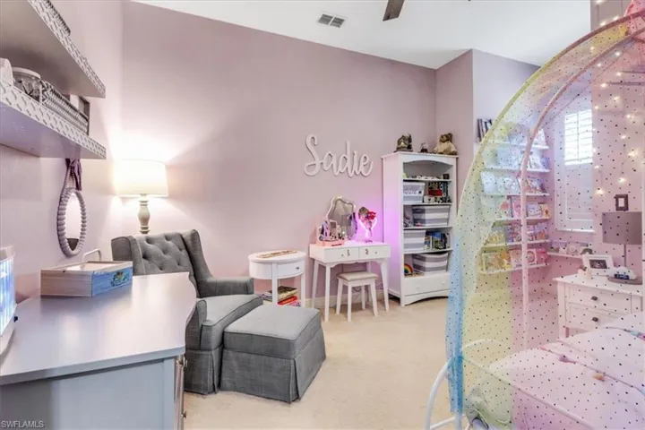 Bedroom featuring light carpet and baseboards